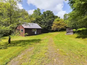 Picturesque Camp Property with Private Trails & Trout Pond on 17 Acres. $199,000